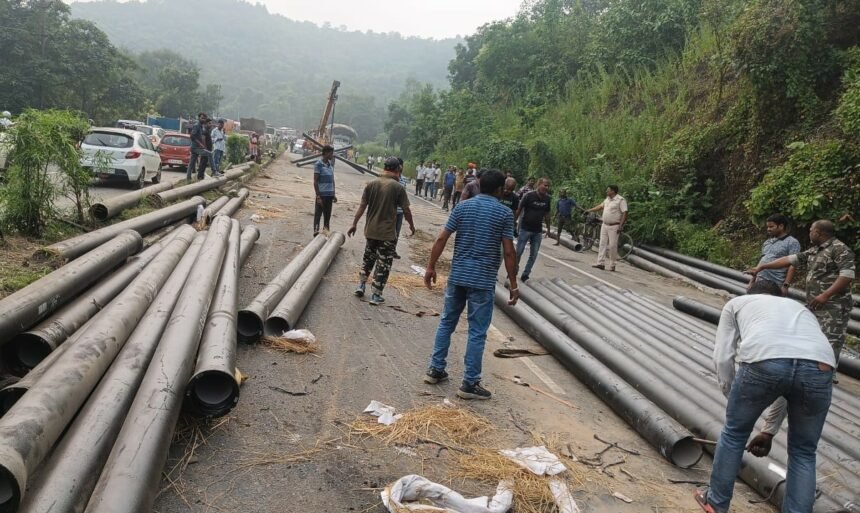 Pipe loaded Trailer Overturned